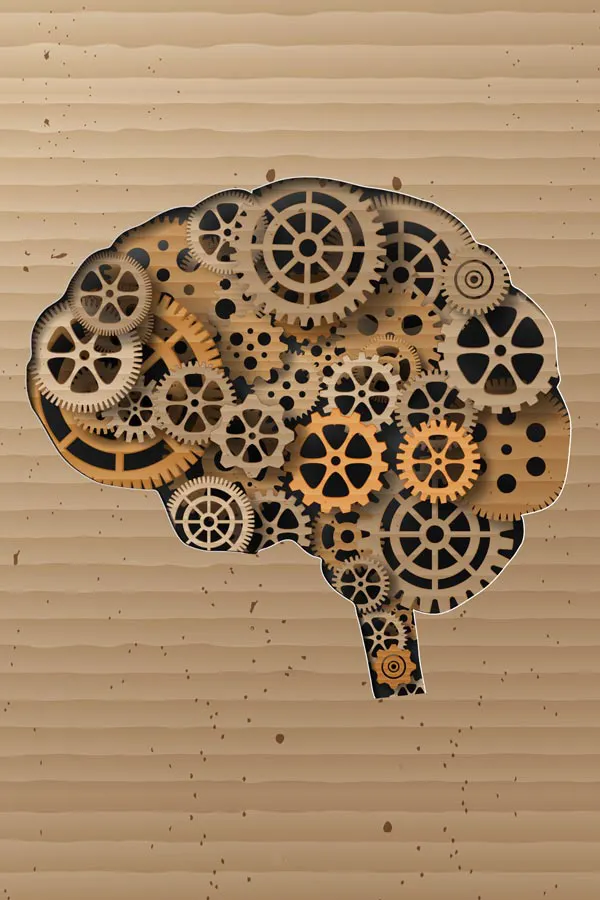Brain-and-Cognitive-Health-Treatment A cut paper illustration of gears inside a silhouette of a human brain. Get brain health and cognitive optimization treatment from AZENA Health & Longevity in Gainesville.